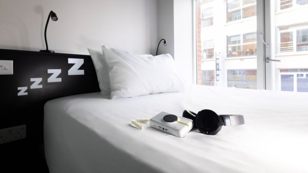 Camera and headphones on bed